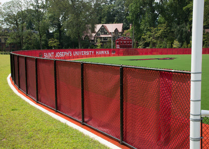 Fencemate windscreen - Red fence with 'Saint Joseph's University Hawks' branding on a sports field.