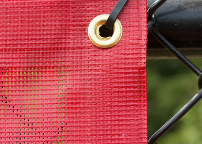 Fencemate windscreen - Red mesh screen with a gold grommet and black metal frame.