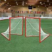 Jaypro LG-44BPKG official size 4x4 box lacrosse goal package featuring a 2-inch zinc-coated orange steel frame and 4mm knotless net.  Shown on the field