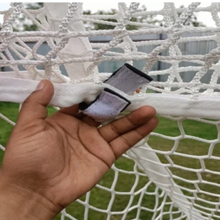 Close-up detail of the Rage Cage Net Saver showcasing the heavy-duty Velcro connection straps that securely fasten the 4mm reinforcement netting directly to the lacrosse goal crossbar.