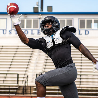 an athlete is wearing the Champro Falcon All-Purpose Shoulder Pad and showing how it fits during play