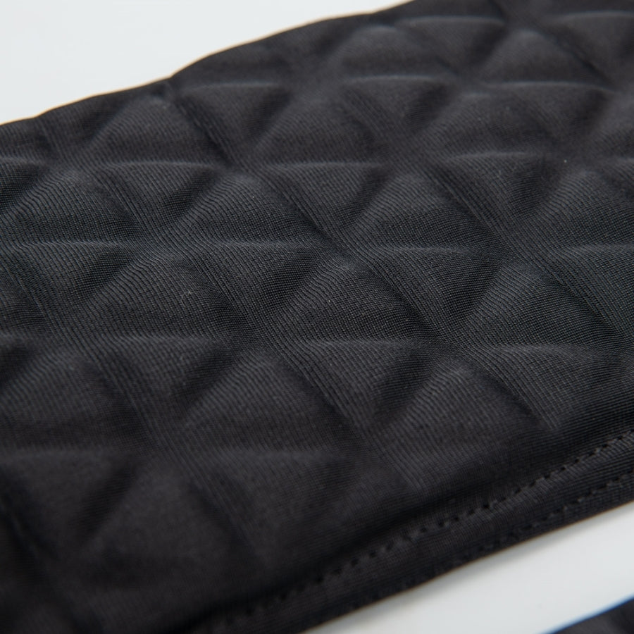 Close-up detail of the Tri-Flex cushion system on the forearm sleeve, clearly displaying the individual triangular foam segments that allow the padding to bend and flex without restricting arm movement.
