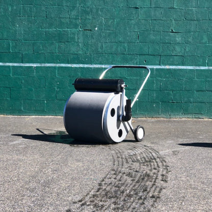 Detail view of the Super Sopper water roller showing the 14-gallon water removal drum, squeeze roller mechanism, and drain elbow.