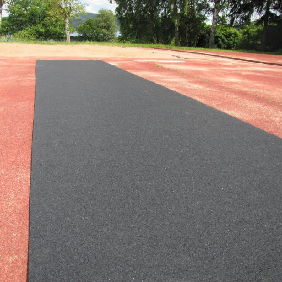 ortable roll-out track runway surface laid out on a practice field, providing a durable and protective rubber lane for triple jump and track events.