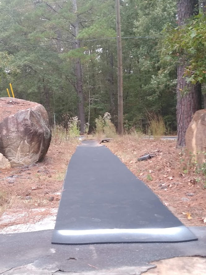 A picture of a javelin training school using roll out runway in their outdoor throwing area as a run up.